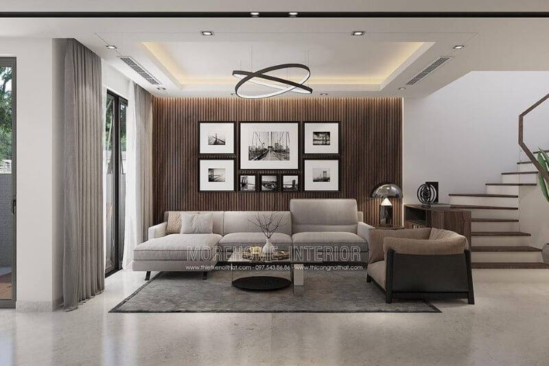 Trang trí tường phòng khách đẹp độc đáo với gỗ ốp tường kết hợp tranh đen trắng phong cảnh. Thiết kế phòng khách nhà phố